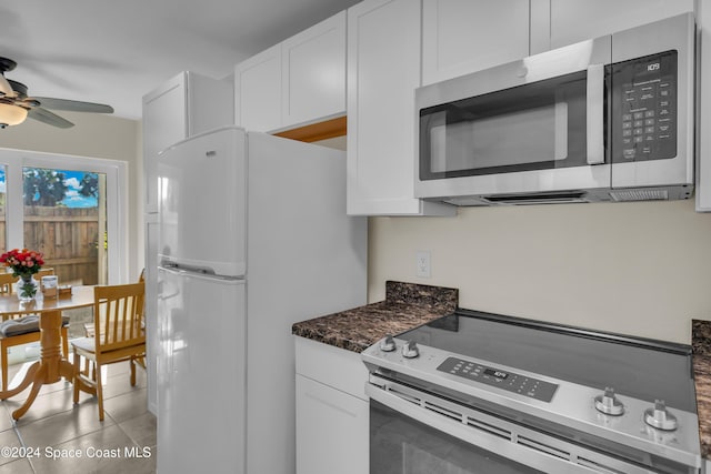 kitchen with ceiling fan, light tile patterned flooring, white refrigerator, electric stove, and white cabinets