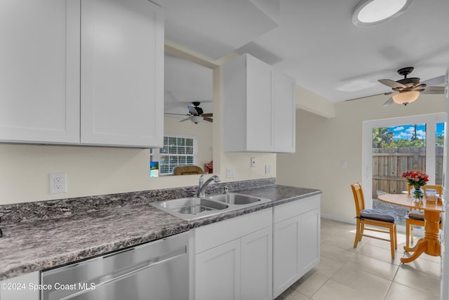 kitchen with stainless steel dishwasher, ceiling fan, sink, light tile patterned floors, and white cabinets