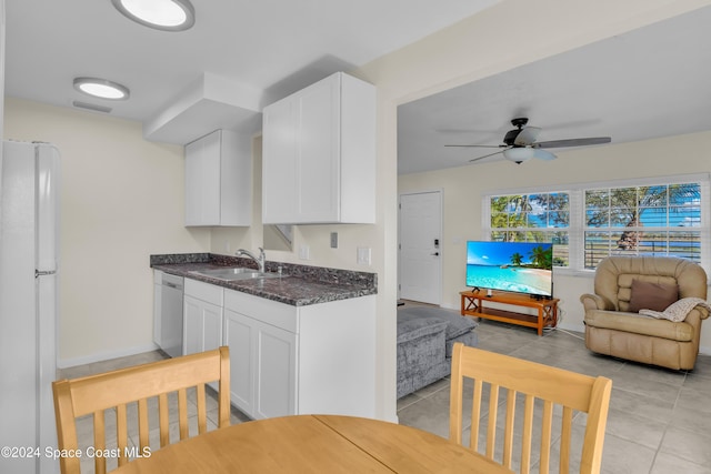 516 S Plumosa St Unit 20, Merritt Island, FL 32952 - kitchen featuring freestanding refrigerator, dishwasher, white cabinets, open floor plan, and light tile patterned floors