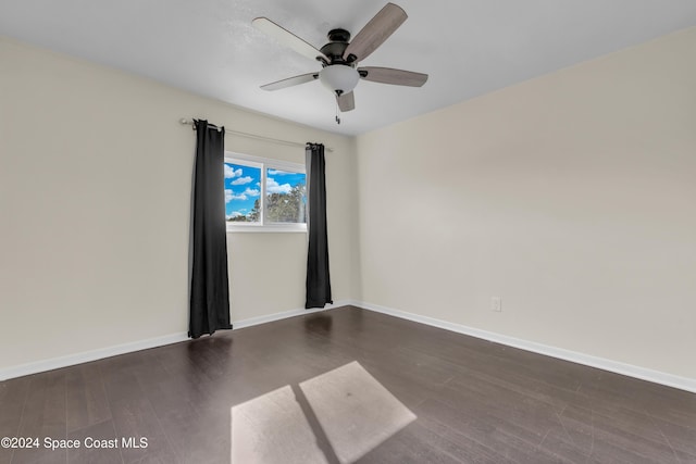 unfurnished room featuring ceiling fan and dark hardwood / wood-style flooring