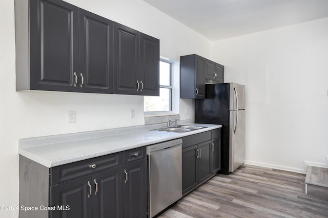 kitchen featuring light hardwood / wood-style floors, sink, and appliances with stainless steel finishes