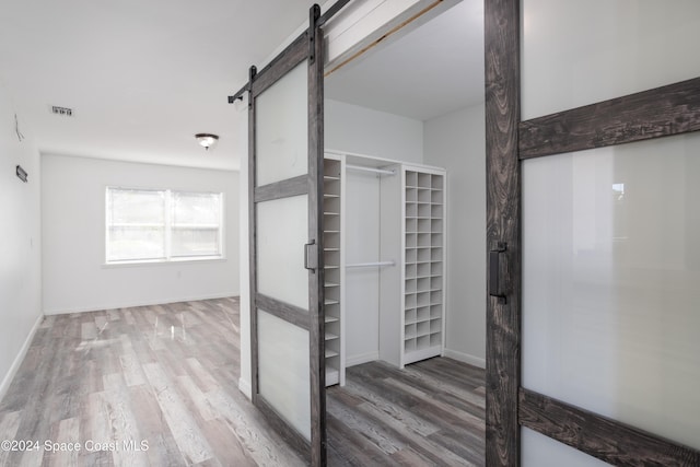 interior space featuring a barn door and wood-type flooring