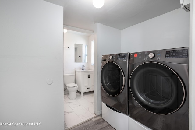 clothes washing area featuring washing machine and dryer and sink