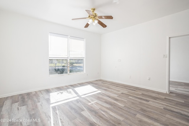 unfurnished room with ceiling fan and light wood-type flooring