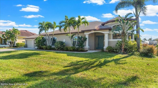 view of front facade featuring a front yard and a garage