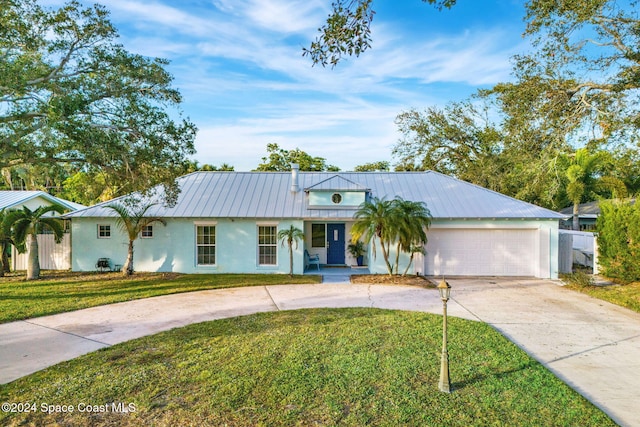 ranch-style home with a garage and a front lawn