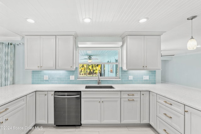 kitchen featuring dishwasher, sink, kitchen peninsula, decorative light fixtures, and white cabinets