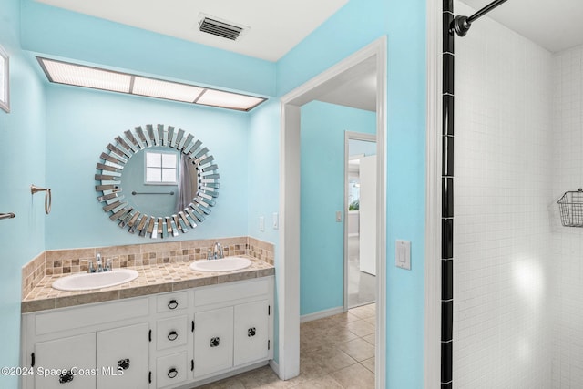 bathroom with tile patterned flooring and vanity