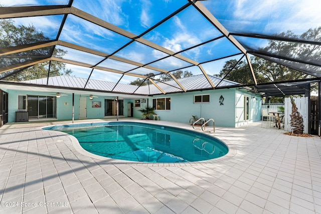 view of pool featuring ceiling fan, a lanai, and a patio