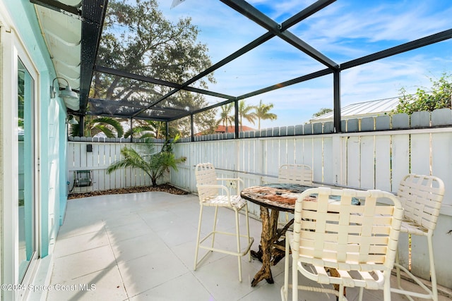 view of patio featuring a lanai