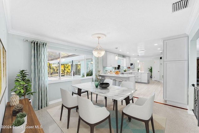 dining area with a chandelier, a textured ceiling, and crown molding