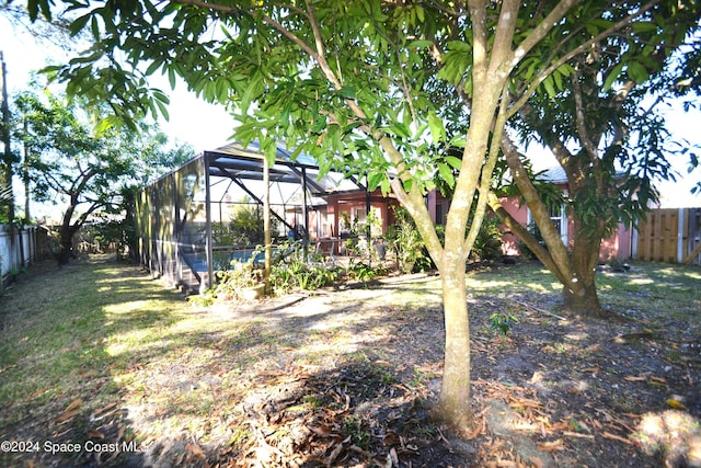 view of yard featuring glass enclosure