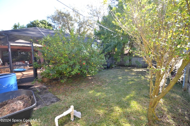 view of yard featuring glass enclosure