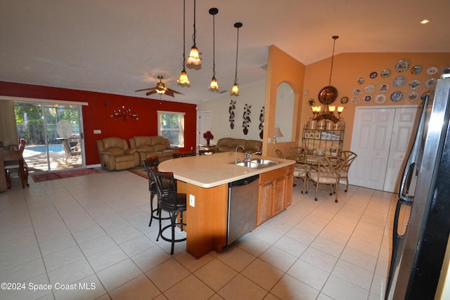 kitchen featuring pendant lighting, ceiling fan, light tile patterned floors, an island with sink, and stainless steel appliances