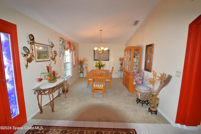 carpeted dining space featuring a textured ceiling and a notable chandelier