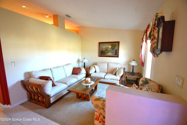 tiled living room featuring vaulted ceiling