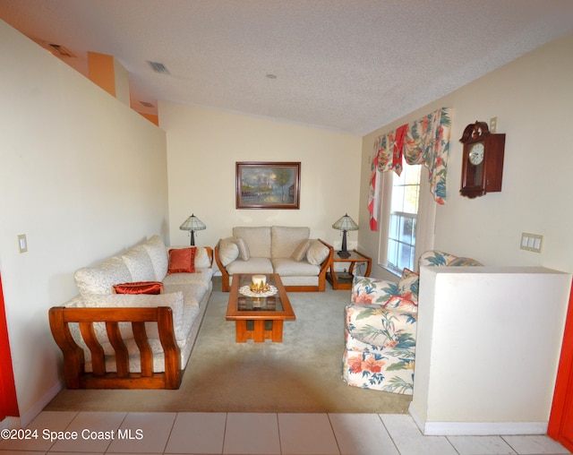 living room with a textured ceiling, light tile patterned floors, and lofted ceiling