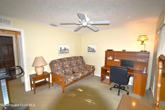 office space with ceiling fan, light colored carpet, and a textured ceiling