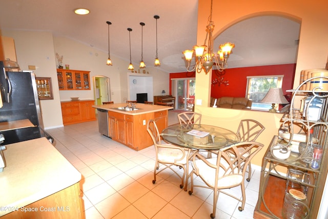 dining area with light tile patterned floors, vaulted ceiling, a notable chandelier, and sink