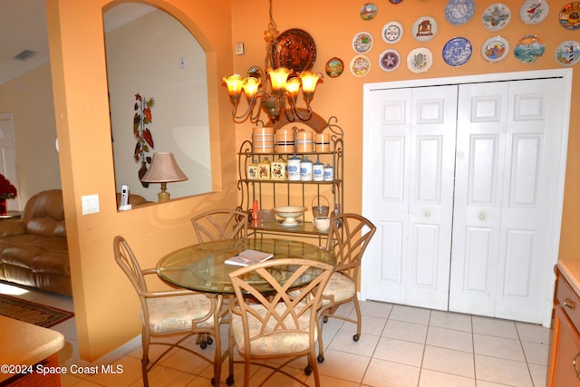 dining area featuring a chandelier and light tile patterned floors