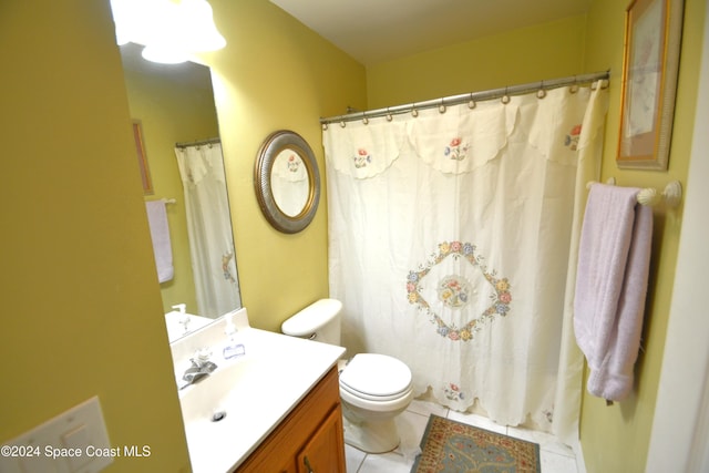 bathroom featuring curtained shower, tile patterned flooring, vanity, and toilet