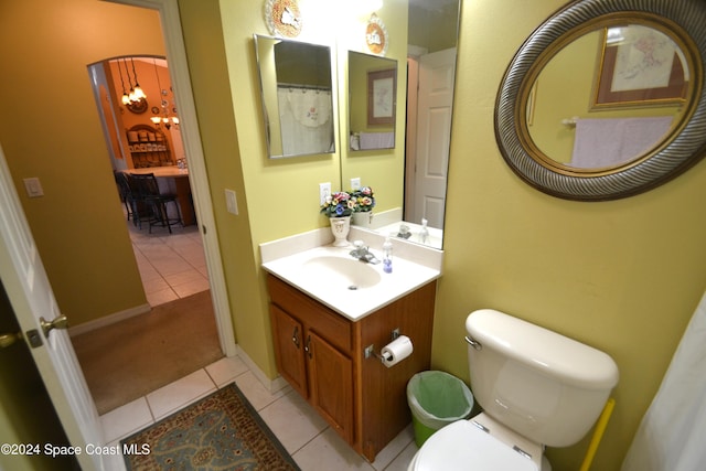 bathroom with tile patterned flooring, vanity, and toilet