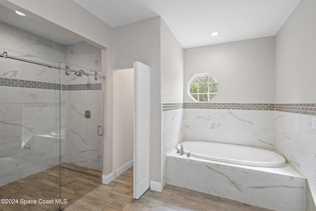 bathroom with hardwood / wood-style floors and plus walk in shower