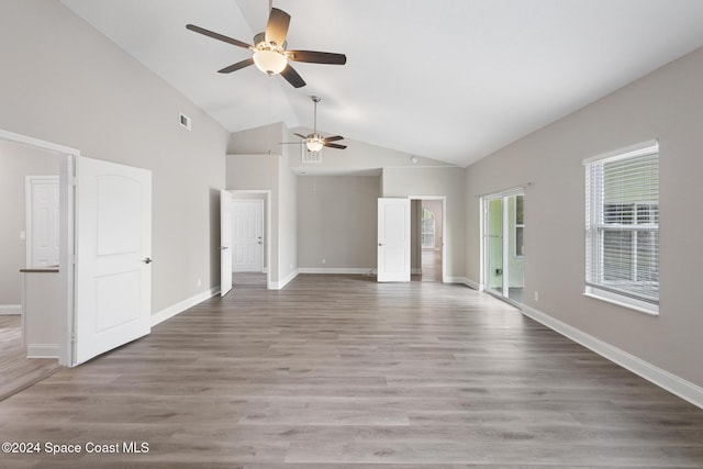 unfurnished living room featuring hardwood / wood-style flooring, ceiling fan, and high vaulted ceiling