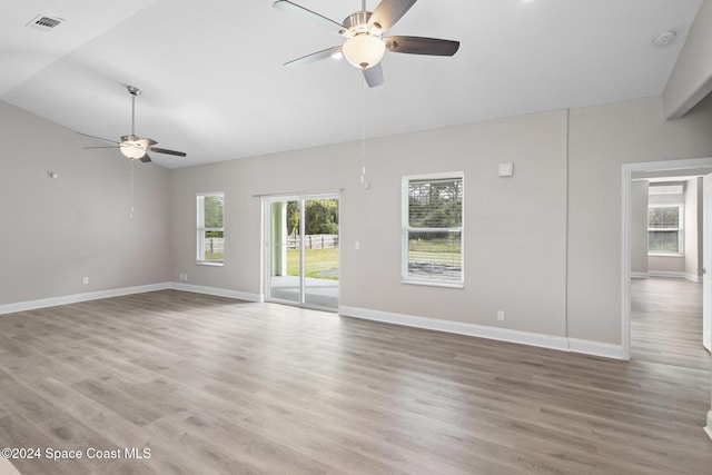 spare room featuring lofted ceiling, ceiling fan, and wood-type flooring