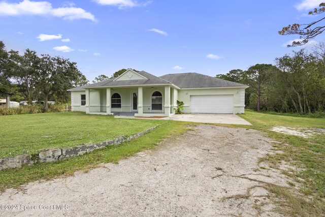 view of front of property with a front lawn, a porch, and a garage