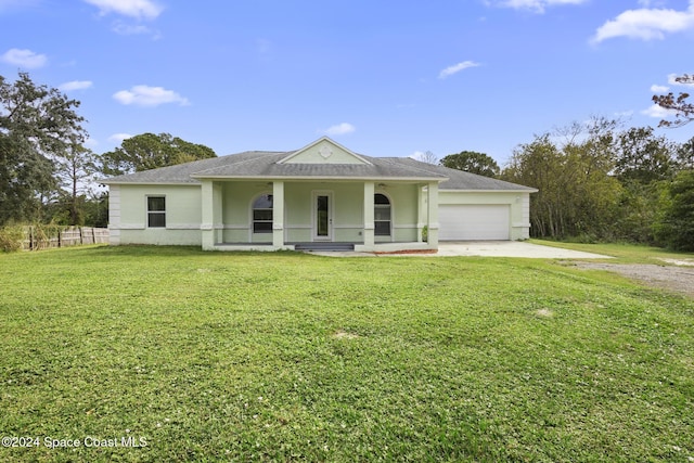 view of front of property featuring a front yard, a porch, and a garage