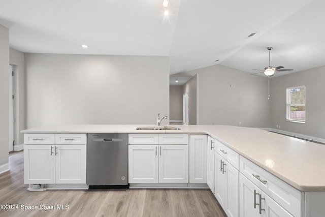 kitchen featuring sink, white cabinets, stainless steel dishwasher, and light hardwood / wood-style flooring