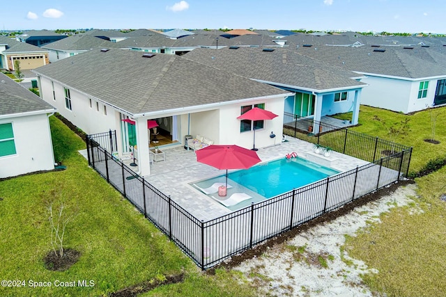 view of swimming pool with a patio area and a lawn