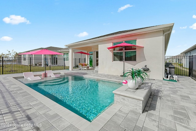 view of swimming pool featuring a patio