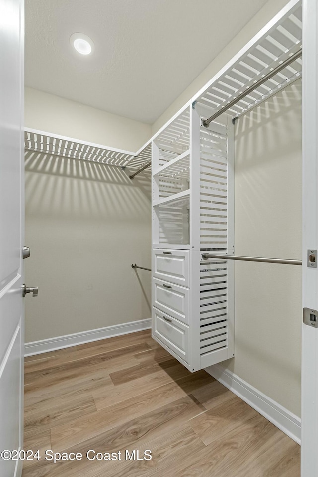 walk in closet featuring light hardwood / wood-style flooring