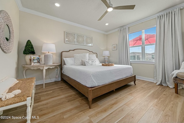 bedroom featuring a textured ceiling, light hardwood / wood-style floors, ceiling fan, and crown molding