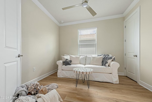 living room with light hardwood / wood-style floors, ceiling fan, and crown molding