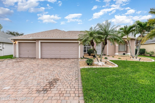 ranch-style home featuring a garage and a front lawn