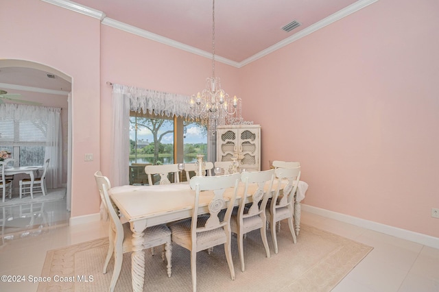 tiled dining room with an inviting chandelier, crown molding, and a water view