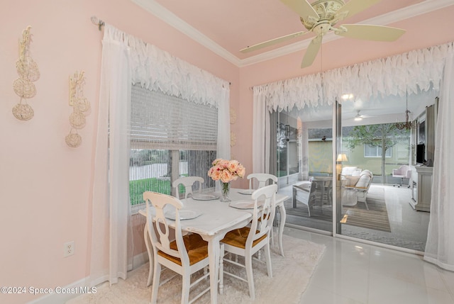 tiled dining space with ceiling fan and ornamental molding