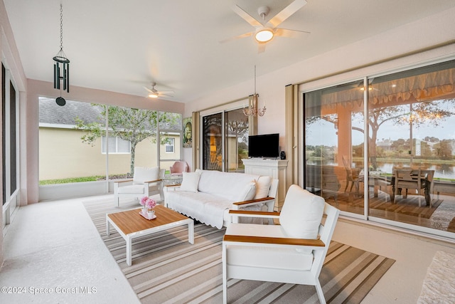 sunroom with ceiling fan with notable chandelier