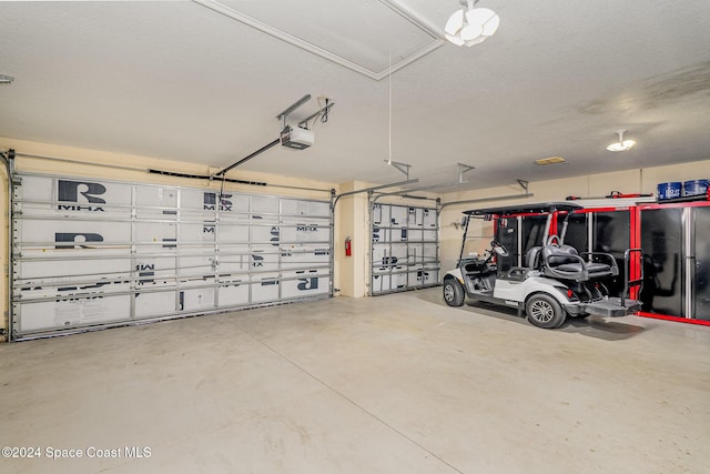 garage with a garage door opener and stainless steel refrigerator