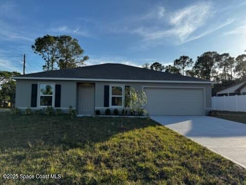 single story home with a garage and a front yard