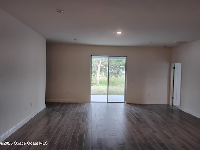 spare room with dark wood-type flooring