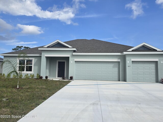 ranch-style home with a garage and a front yard