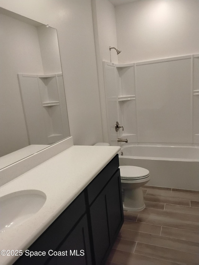 full bathroom with shower / tub combination, vanity, and toilet