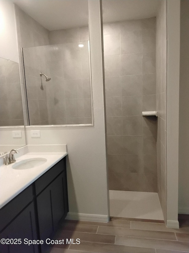 bathroom featuring vanity and tiled shower