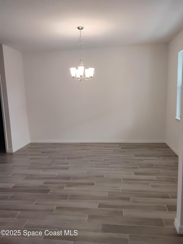 empty room with an inviting chandelier