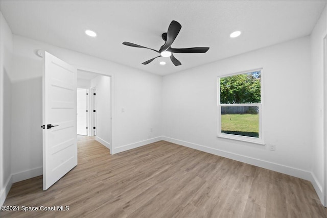 empty room featuring ceiling fan and light hardwood / wood-style flooring