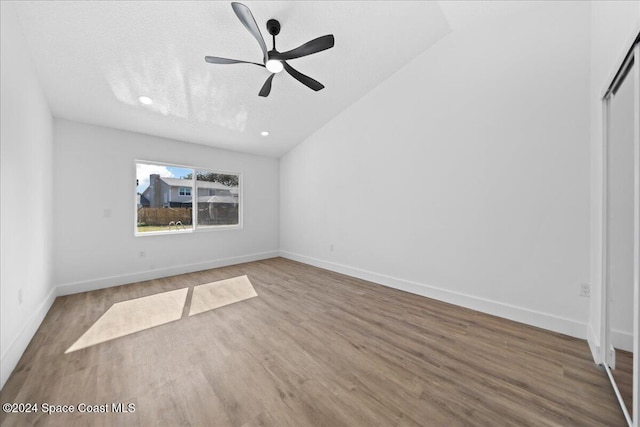 interior space featuring hardwood / wood-style floors, ceiling fan, lofted ceiling, and a textured ceiling